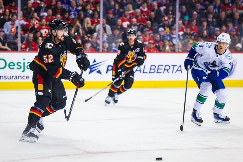 Dec 2, 2023; Calgary, Alberta, CAN; Calgary Flames defenseman MacKenzie Weegar (52) passes the puck against the Vancouver Canucks during the first period at Scotiabank Saddledome. Mandatory Credit: Sergei Belski-USA TODAY Sports