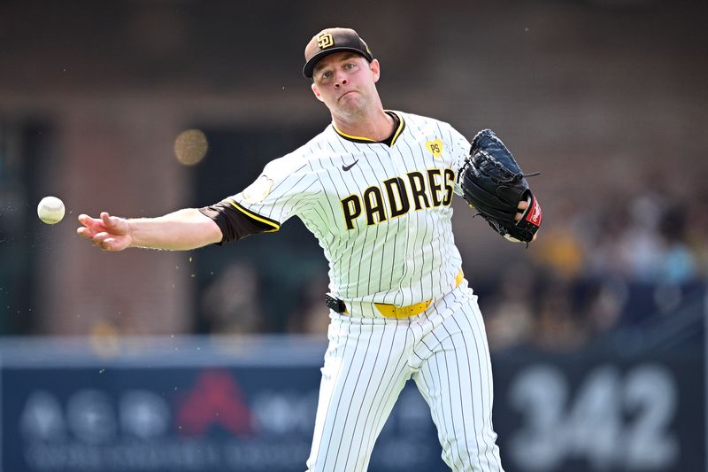 Jul 10, 2024; San Diego, California, USA; San Diego Padres starting pitcher Michael King (34) throws to first base on a ground out by Seattle Mariners third baseman Josh Rojas (not pictured) during the second inning at Petco Park. Mandatory Credit: Orlando Ramirez-USA TODAY Sports