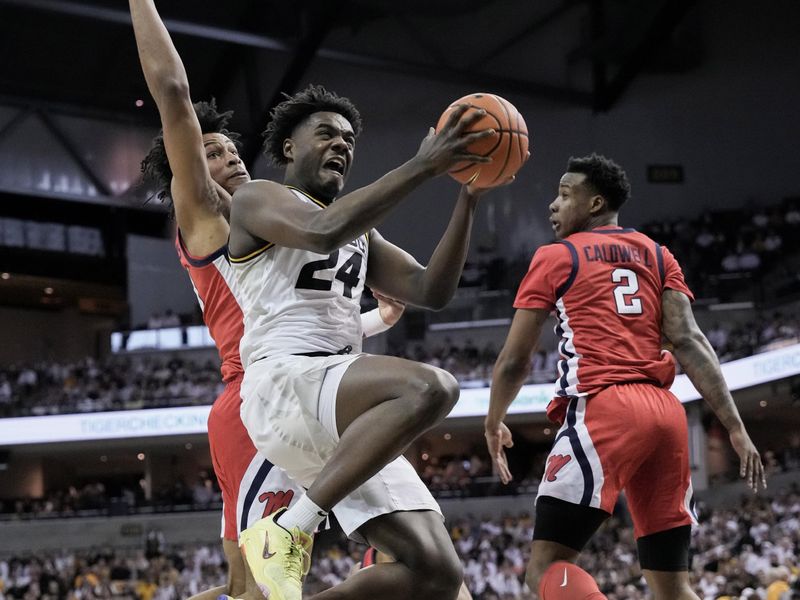 Mar 4, 2023; Columbia, Missouri, USA; Missouri Tigers guard Kobe Brown (24) shoots as Mississippi Rebels forward Jayveous McKinnis (00) defends during the first half at Mizzou Arena. Mandatory Credit: Denny Medley-USA TODAY Sports