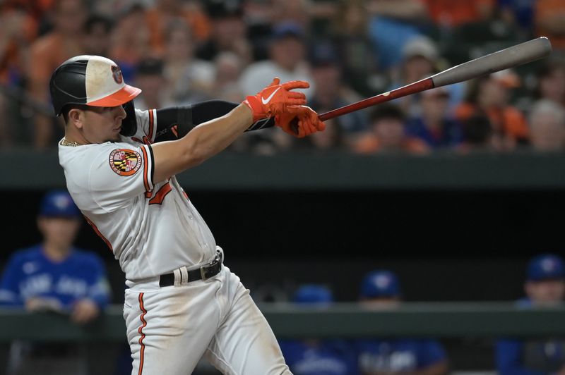 Aug 23, 2023; Baltimore, Maryland, USA;  Baltimore Orioles third baseman Ramon Urias (29) hits a rbi single against the Toronto Blue Jays in the eighth inning at Oriole Park at Camden Yards. Mandatory Credit: Tommy Gilligan-USA TODAY Sports