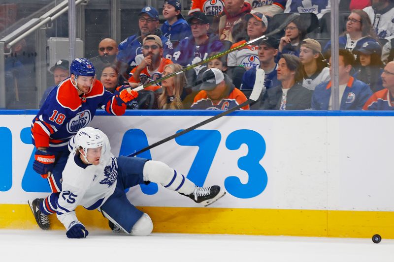 Feb 3, 2026; Edmonton, Alberta, CAN; Edmonton Oilers forward Zach Hyman (18) and Toronto Maple Leafs defensemen Brandon Carlo (25) battle along the boards for a loose puck during the first period at Rogers Place. Mandatory Credit: Perry Nelson-Imagn Images
