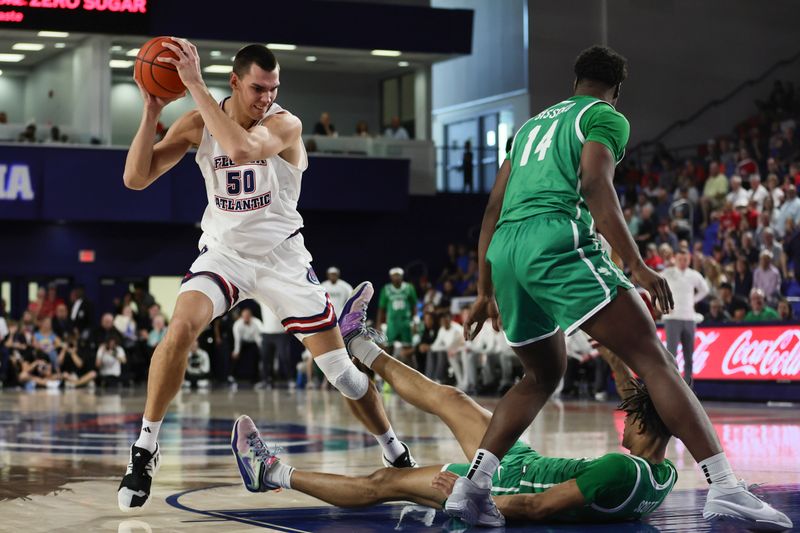 Jan 28, 2024; Boca Raton, Florida, USA; Florida Atlantic Owls center Vladislav Goldin (50) protects the basketball from North Texas Mean Green forward Aaron Scott (1) and forward Moulaye Sissoko (14) during the second half at Eleanor R. Baldwin Arena. Mandatory Credit: Sam Navarro-USA TODAY Sports