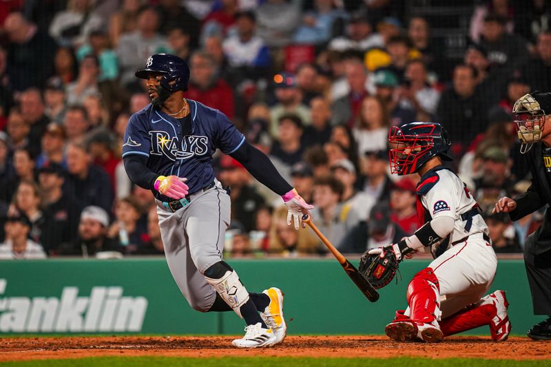 Jun 10, 2025; Boston, Massachusetts, USA; Tampa Bay Rays first base Yandy Díaz (2) gets a base hit to drive in a run against the Boston Red Sox in the fifth inning at Fenway Park. Mandatory Credit: David Butler II-Imagn Images