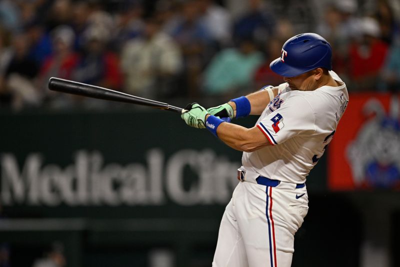 Sep 17, 2024; Arlington, Texas, USA; Texas Rangers first baseman Nathaniel Lowe (30) breaks his bat as he hits a single and drives in a run against the Toronto Blue Jays during the fourth inning at Globe Life Field. Mandatory Credit: Jerome Miron-Imagn Images