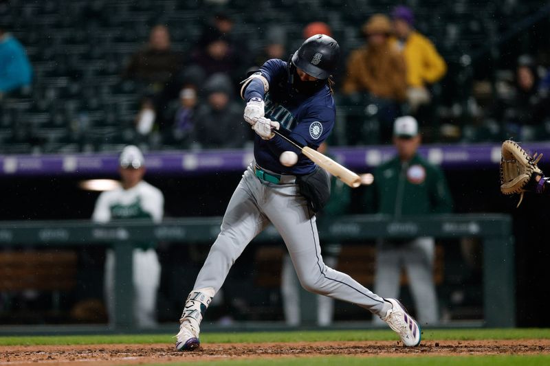 Apr 20, 2024; Denver, Colorado, USA; Seattle Mariners shortstop J.P. Crawford (3) hits a single in the seventh inning against the Colorado Rockies at Coors Field. Mandatory Credit: Isaiah J. Downing-USA TODAY Sports