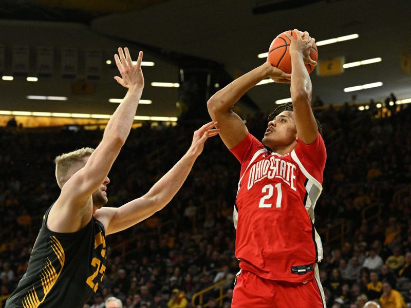 Feb 2, 2024; Iowa City, Iowa, USA; Ohio State Buckeyes forward Devin Royal (21) shoots the ball over Iowa Hawkeyes forward Ben Krikke (23) during the first half at Carver-Hawkeye Arena. Mandatory Credit: Jeffrey Becker-USA TODAY Sports