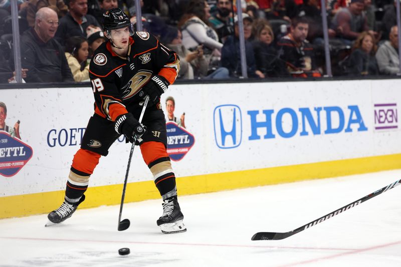 Dec 21, 2023; Anaheim, California, USA;  Anaheim Ducks right wing Troy Terry (19) passes the puck during the second period against the Calgary Flames at Honda Center. Mandatory Credit: Kiyoshi Mio-USA TODAY Sports