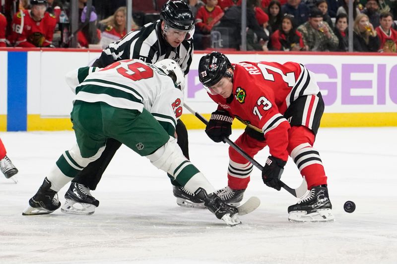 Jan 26, 2025; Chicago, Illinois, USA; Minnesota Wild center Frederick Gaudreau (89) and Chicago Blackhawks left wing Lukas Reichel (73) face-off during the first period at United Center. Mandatory Credit: David Banks-Imagn Images