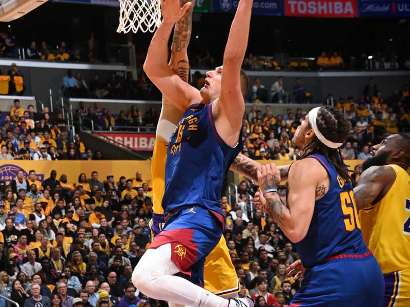 LOS ANGELES, CA - APRIL 25: Nikola Jokic #15 of the Denver Nuggets drives to the basket during the game against the Los Angeles Lakers during Round 1 Game 3 of the 2024 NBA Playoffs on April 25, 2024 at Crypto.Com Arena in Los Angeles, California. NOTE TO USER: User expressly acknowledges and agrees that, by downloading and/or using this Photograph, user is consenting to the terms and conditions of the Getty Images License Agreement. Mandatory Copyright Notice: Copyright 2024 NBAE (Photo by Andrew D. Bernstein/NBAE via Getty Images)