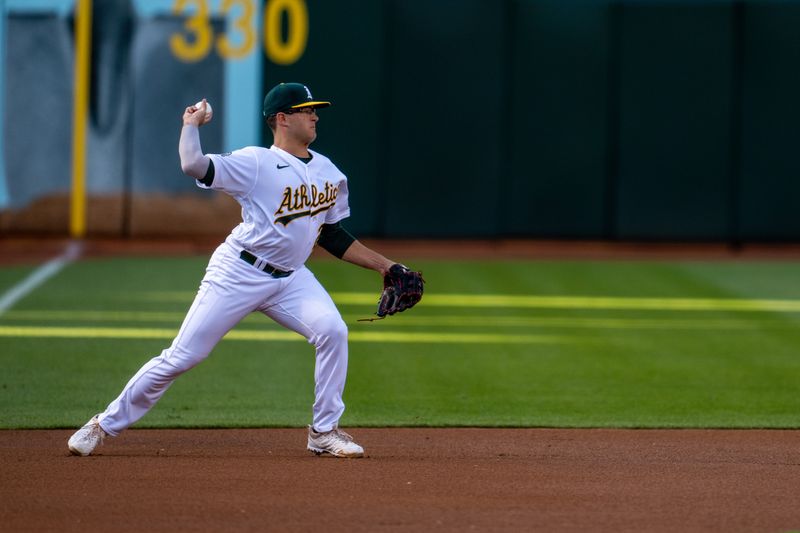 May 30, 2023; Oakland, California, USA;  Oakland Athletics third baseman Jonah Bride (26) starts the double play against the Atlanta Braves during the first inning at Oakland-Alameda County Coliseum. Mandatory Credit: Neville E. Guard-USA TODAY Sports