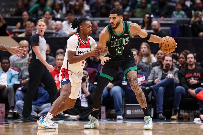 WASHINGTON, DC - OCTOBER 24: Jayson Tatum #0 of the Boston Celtics handles the ball as Bub Carrington #8 of the Washington Wizards defends during the first half at Capital One Arena on October 24, 2024 in Washington, DC. NOTE TO USER: User expressly acknowledges and agrees that, by downloading and or using this photograph, User is consenting to the terms and conditions of the Getty Images License Agreement. (Photo by Scott Taetsch/Getty Images)