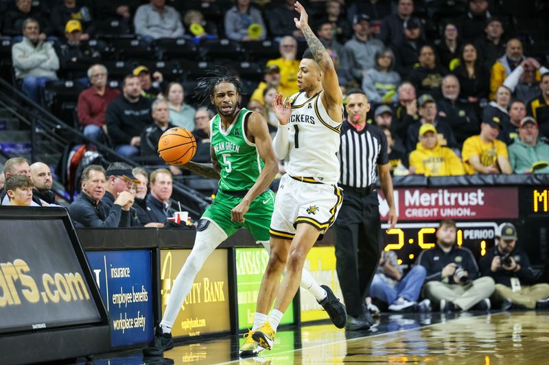 Jan 29, 2025; Wichita, Kansas, USA;  Wichita State Shockers guard Xavier Bell (1) blocks North Texas Mean Green guard Rondel Walker (5) during the first half at Charles Koch Arena. Mandatory Credit: William Purnell-Imagn Images