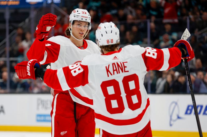 Feb 19, 2024; Seattle, Washington, USA; Detroit Red Wings defenseman Moritz Seider (53) celebrates with right wing Patrick Kane (88) after scoring a goal against the Seattle Kraken during the first period at Climate Pledge Arena. Mandatory Credit: Joe Nicholson-USA TODAY Sports