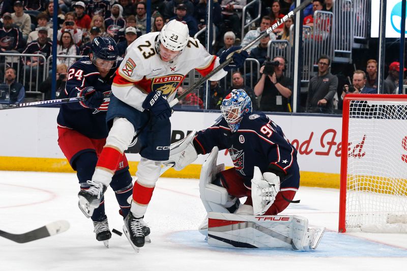 Oct 15, 2024; Columbus, Ohio, USA; Florida Panthers center Carter Verhaeghe (23) jumps over a rebound of a Columbus Blue Jackets goalie Elvis Merzlikins (90) save during the third period at Nationwide Arena. Mandatory Credit: Russell LaBounty-Imagn Images