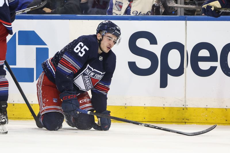 Mar 5, 2025; New York, New York, USA;  New York Rangers left wing Brett Berard (65) gets up off the ice following a collision in the first period against the Washington Capitals at Madison Square Garden. Mandatory Credit: Wendell Cruz-Imagn Images