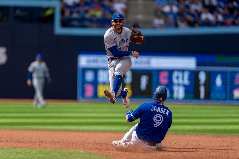 Aug 13, 2023; Toronto, Ontario, CAN; Chicago Cubs shortstop Dansby Swanson (7) turns the double play against the Toronto Blue Jays during the sixth inning at Rogers Centre. Mandatory Credit: Kevin Sousa-USA TODAY Sports