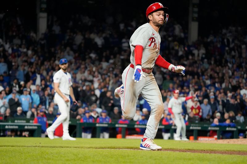 Apr 27, 2025; Chicago, Illinois, USA; Philadelphia Phillies shortstop Trea Turner (7) beats out a one run infield single against the Chicago Cubs during the tenth inning at Wrigley Field. Mandatory Credit: David Banks-Imagn Images