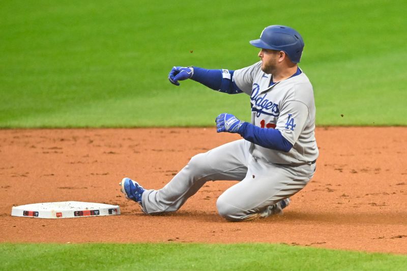 Aug 23, 2023; Cleveland, Ohio, USA; Los Angeles Dodgers designated hitter Max Muncy (13) slides to second base on his double in the first inning against the Cleveland Guardians at Progressive Field. Mandatory Credit: David Richard-USA TODAY Sports