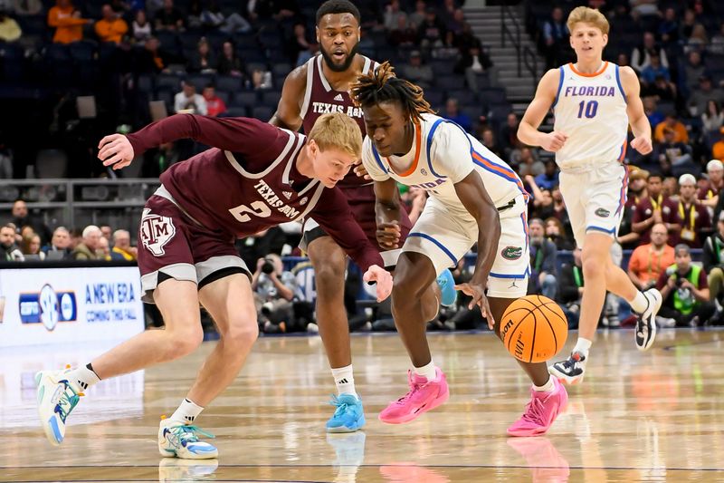 Mar 16, 2024; Nashville, TN, USA;  Texas A&M Aggies guard Hayden Hefner (2) pokes the ball from Florida Gators guard Denzel Aberdeen (11) during the second half at Bridgestone Arena. Mandatory Credit: Steve Roberts-USA TODAY Sports