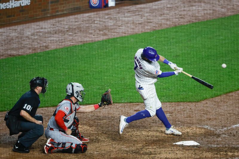 Jun 2, 2024; Chicago, Illinois, USA; Chicago Cubs shortstop Dansby Swanson (7) hits a two-run home run against the Cincinnati Reds during the eight inning at Wrigley Field. Mandatory Credit: Kamil Krzaczynski-USA TODAY Sports