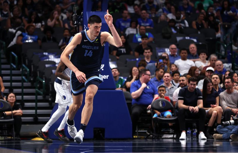 DALLAS, TX - OCTOBER 7: Zach Edey #14 of the Memphis Grizzlies celebrates scoring a basket against the Dallas Mavericks in the first half of a preseason game at American Airlines Center on October 7, 2024 in Dallas, Texas. NOTE TO USER: User expressly acknowledges and agrees that, by downloading and or using this photograph, User is consenting to the terms and conditions of the Getty Images License Agreement. (Photo by Ron Jenkins/Getty Images)