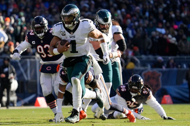 Philadelphia Eagles' Jalen Hurts runs for a touchdown during the first half of an NFL football game against the Chicago Bears, Sunday, Dec. 18, 2022, in Chicago. (AP Photo/Nam Y. Huh)