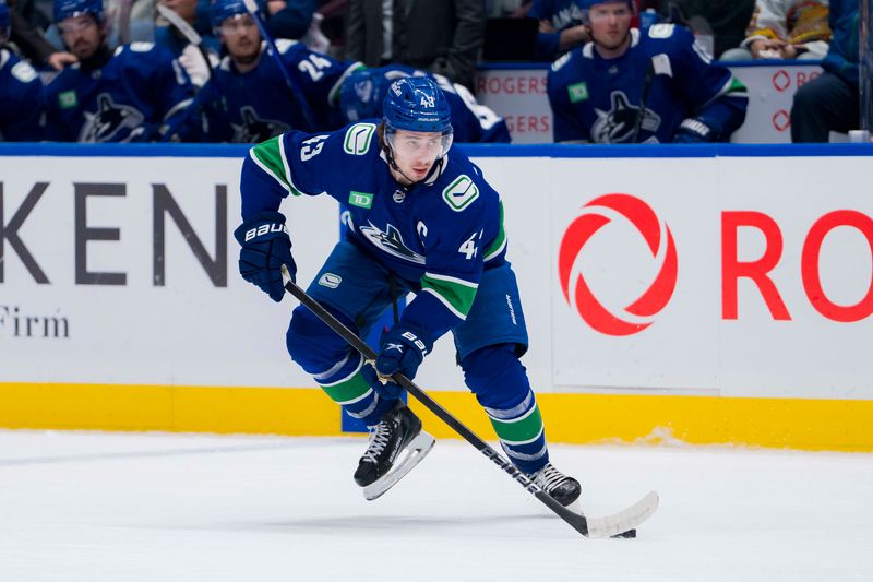 Feb 17, 2024; Vancouver, British Columbia, CAN; Vancouver Canucks defenseman Quinn Hughes (43) handles the puck against the Winnipeg Jets in the second period at Rogers Arena. Mandatory Credit: Bob Frid-USA TODAY Sports