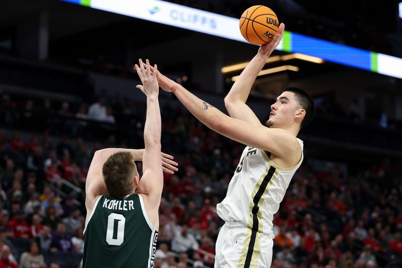 Mar 15, 2024; Minneapolis, MN, USA; Purdue Boilermakers center Zach Edey (15) shoots as Michigan State Spartans forward Jaxon Kohler (0) defends during the first half at Target Center. Mandatory Credit: Matt Krohn-USA TODAY Sports