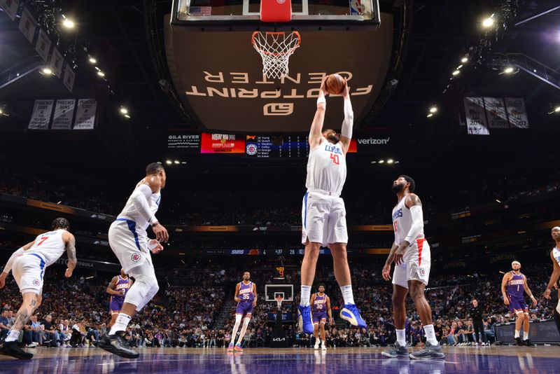 PHOENIX, AZ - APRIL 9:  Ivica Zubac #40 of the LA Clippers grabs the rebound during the game on April 9, 2024 at Footprint Center in Phoenix, Arizona. NOTE TO USER: User expressly acknowledges and agrees that, by downloading and or using this photograph, user is consenting to the terms and conditions of the Getty Images License Agreement. Mandatory Copyright Notice: Copyright 2024 NBAE (Photo by Barry Gossage/NBAE via Getty Images)