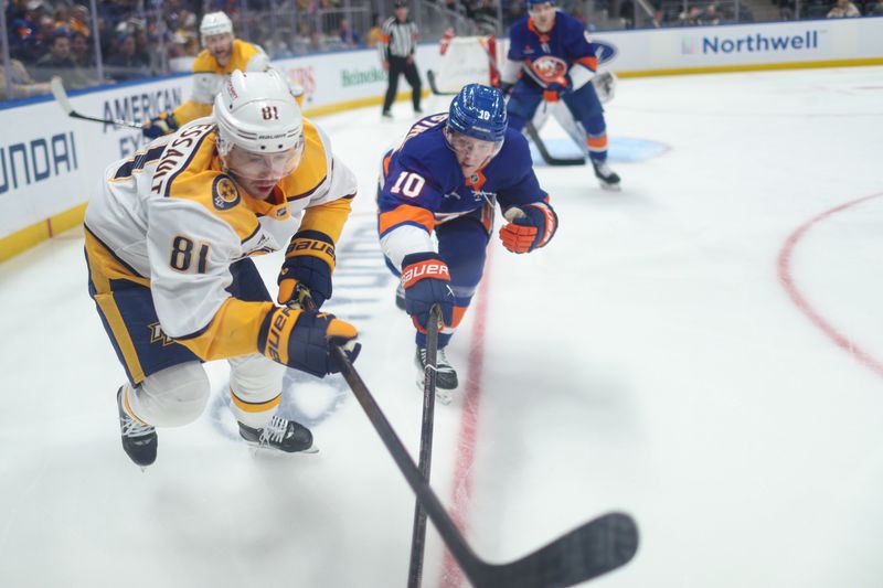 Mar 1, 2025; Elmont, New York, USA;  Nashville Predators center Jonathan Marchessault (81) and New York Islanders right wing Simon Holmstrom (10) go for the puck during the third period at UBS Arena. Mandatory Credit: Thomas Salus-Imagn Images