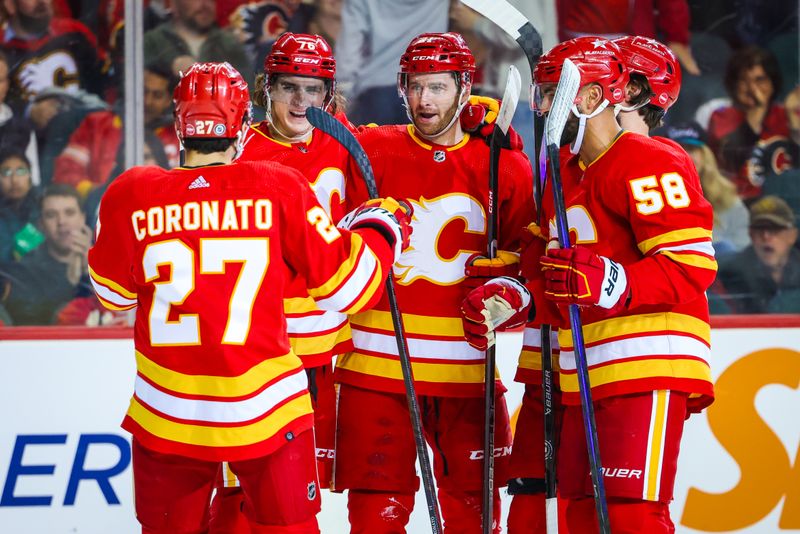 Apr 18, 2024; Calgary, Alberta, CAN; Calgary Flames center Kevin Rooney (21) celebrates his goal with teammates against the San Jose Sharks during the second period at Scotiabank Saddledome. Mandatory Credit: Sergei Belski-USA TODAY Sports