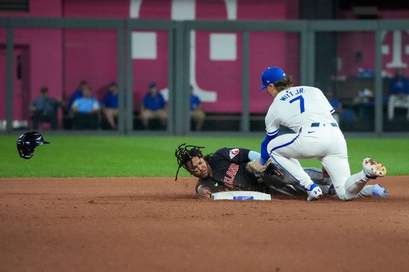 Sep 3, 2024; Kansas City, Missouri, USA; Kansas City Royals shortstop Bobby Witt Jr. (7) gets the out on Cleveland Guardians third baseman José Ramírez (11) trying to steal second base in the seventh inning at Kauffman Stadium. Mandatory Credit: Denny Medley-Imagn Images