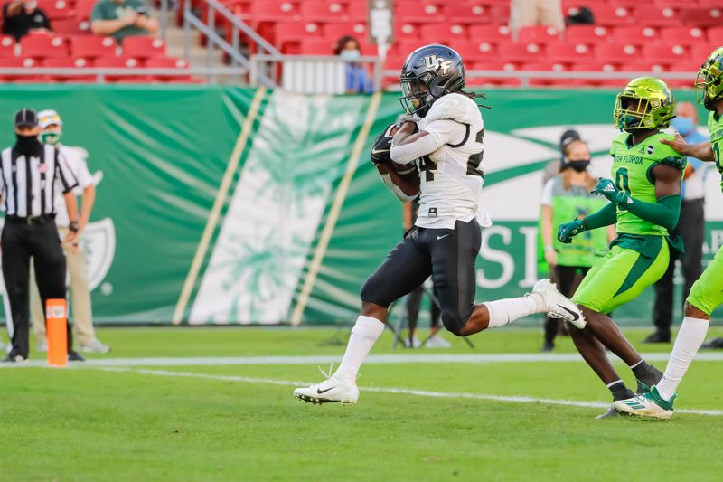 Nov 27, 2020; Tampa, Florida, USA; UCF Knights running back Bentavious Thompson (24) scores a touchdown during the first quarter against the South Florida Bulls at Raymond James Stadium. Mandatory Credit: Mike Watters-USA TODAY Sports