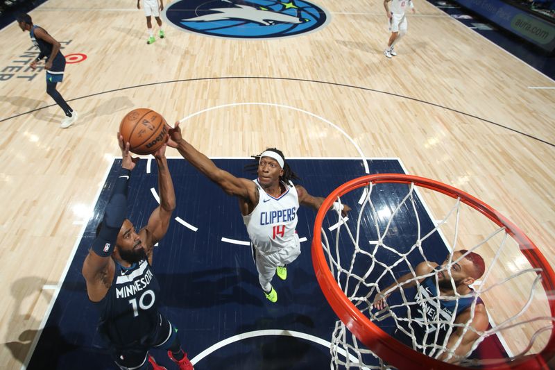 MINNEAPOLIS, MN -  JANUARY 14: Mike Conley #10 of the Minnesota Timberwolves and Terance Mann #14 of the LA Clippers rebound the ball during the game on January 14, 2024 at Target Center in Minneapolis, Minnesota. NOTE TO USER: User expressly acknowledges and agrees that, by downloading and or using this Photograph, user is consenting to the terms and conditions of the Getty Images License Agreement. Mandatory Copyright Notice: Copyright 2024 NBAE (Photo by Jordan Johnson/NBAE via Getty Images)