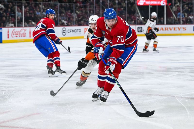 Feb 13, 2024; Montreal, Quebec, CAN; Montreal Canadiens left wing Tanner Pearson (70) plays the puck against Anaheim Ducks defenseman Urho Vaakanainen (5) during the first period at Bell Centre. Mandatory Credit: David Kirouac-USA TODAY Sports