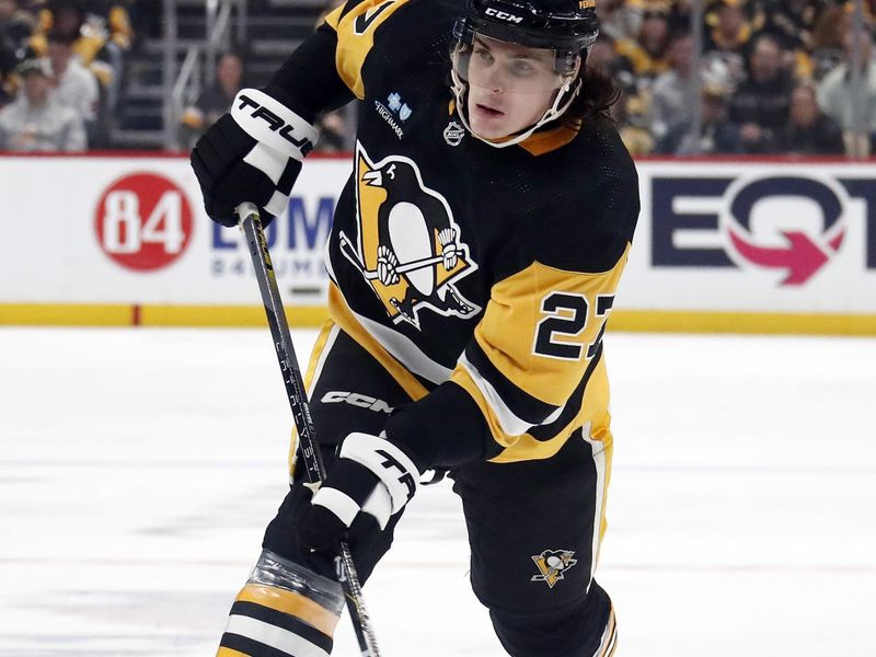 Feb 20, 2024; Pittsburgh, Pennsylvania, USA; Pittsburgh Penguins defenseman Ryan Graves (27) shoots the puck against the New York Islanders during the third period at PPG Paints Arena. New York won 5-4 in overtime. Mandatory Credit: Charles LeClaire-USA TODAY Sports