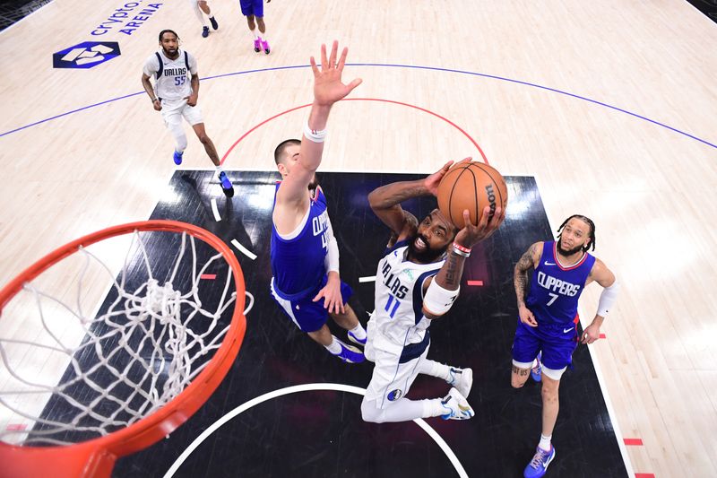 LOS ANGELES, CA - APRIL 21:  Kyrie Irving #11 of the Dallas Mavericks drives to the basket during the game against the LA Clippers during Round 1 Game 1 of the 2024 NBA Playoffs on April 21, 2024 at Crypto.Com Arena in Los Angeles, California. NOTE TO USER: User expressly acknowledges and agrees that, by downloading and/or using this Photograph, user is consenting to the terms and conditions of the Getty Images License Agreement. Mandatory Copyright Notice: Copyright 2024 NBAE (Photo by Adam Pantozzi/NBAE via Getty Images)