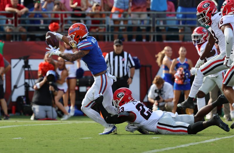 Oct 28, 2023; Jacksonville, Florida, USA; Florida Gators wide receiver Eugene Wilson III (3) runs past Georgia Bulldogs defensive back Tykee Smith (23) for a touchdown during the first quarter at EverBank Stadium. Mandatory Credit: Kim Klement Neitzel-USA TODAY Sports