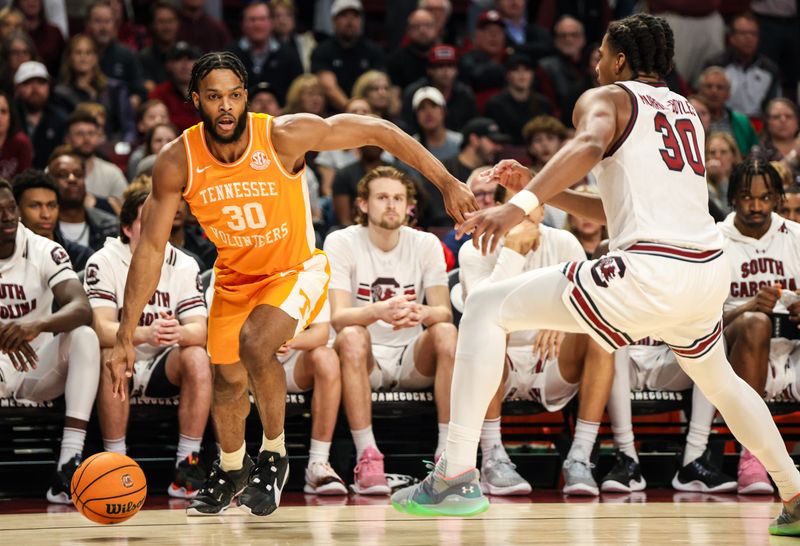 Mar 6, 2024; Columbia, South Carolina, USA; Tennessee Volunteers guard Josiah-Jordan James (30) drives around South Carolina Gamecocks forward Collin Murray-Boyles (30) in the first half at Colonial Life Arena. Mandatory Credit: Jeff Blake-USA TODAY Sports