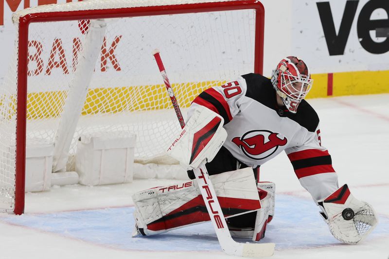 Jan 13, 2024; Sunrise, Florida, USA; New Jersey Devils goaltender Nico Daws (50) makes a save against the Florida Panthers during the third period at Amerant Bank Arena. Mandatory Credit: Sam Navarro-USA TODAY Sports