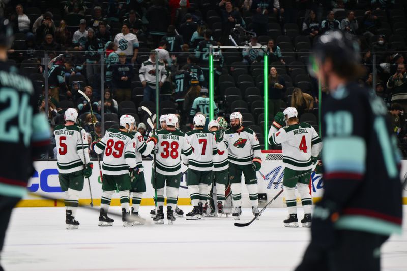 Dec 10, 2023; Seattle, Washington, USA; The Minnesota Wild celebrate after defeating the Seattle Kraken at Climate Pledge Arena. Mandatory Credit: Steven Bisig-USA TODAY Sports