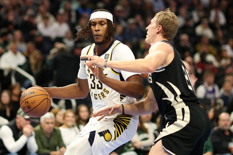 MILWAUKEE, WISCONSIN - NOVEMBER 22: Myles Turner #33 of the Indiana Pacers is defended by AJ Green #20 of the Milwaukee Bucks during the first half of a game in the NBA Emirates Cup at Fiserv Forum on November 22, 2024 in Milwaukee, Wisconsin. NOTE TO USER: User expressly acknowledges and agrees that, by downloading and or using this photograph, User is consenting to the terms and conditions of the Getty Images License Agreement. (Photo by Stacy Revere/Getty Images)