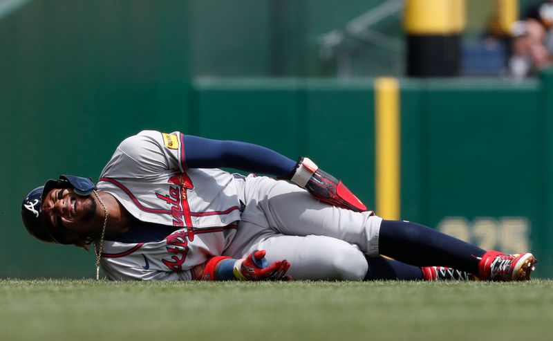 May 26, 2024; Pittsburgh, Pennsylvania, USA;  Atlanta Braves right fielder Ronald Acuña Jr. (13) reacts after suffering an apparent injury on a steal attempt against the Pittsburgh Pirates during the first inning at PNC Park. Mandatory Credit: Charles LeClaire-USA TODAY Sports