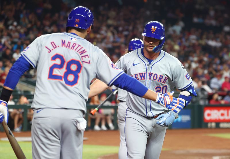 Aug 27, 2024; Phoenix, Arizona, USA; New York Mets first baseman Pete Alonso (right) celebrates with J.D. Martinez after hitting a solo home run in the second inning against the Arizona Diamondbacks at Chase Field. Mandatory Credit: Mark J. Rebilas-USA TODAY Sports