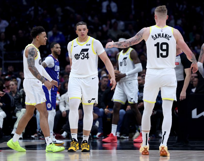 LOS ANGELES, CALIFORNIA - APRIL 12: Kenneth Lofton Jr. #34 of the Utah Jazz celebrates his basket and LA Clippers foul with Keyonte George #3 and Luka Samanic #19 during a 110-109 win at Crypto.com Arena on April 12, 2024 in Los Angeles, California. User is consenting to the terms and conditions of the Getty Images License Agreement.  (Photo by Harry How/Getty Images)