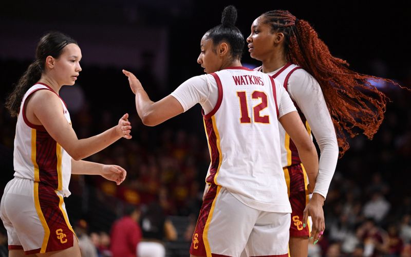 Jan 12, 2025; Los Angeles, California, USA; USC Trojans guards Kayleigh Heckel (left), JuJu Watkins (12) and forward Kiki Iriafen (right) celebrate the Trojans win over the Penn State Nittany Lions at Galen Center. Mandatory Credit: Robert Hanashiro-Imagn Images