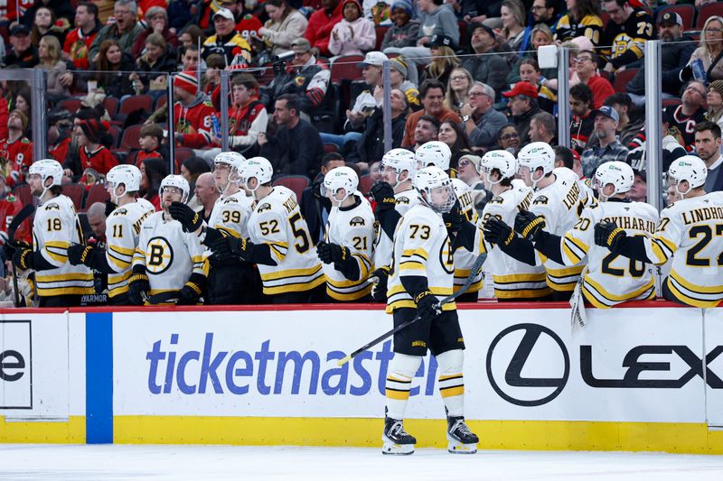 Jan 17, 2026; Chicago, Illinois, USA; Boston Bruins defenseman Charlie McAvoy (73) celebrates with teammates after scoring against the Chicago Blackhawks during the second period at United Center. Mandatory Credit: Kamil Krzaczynski-Imagn Images