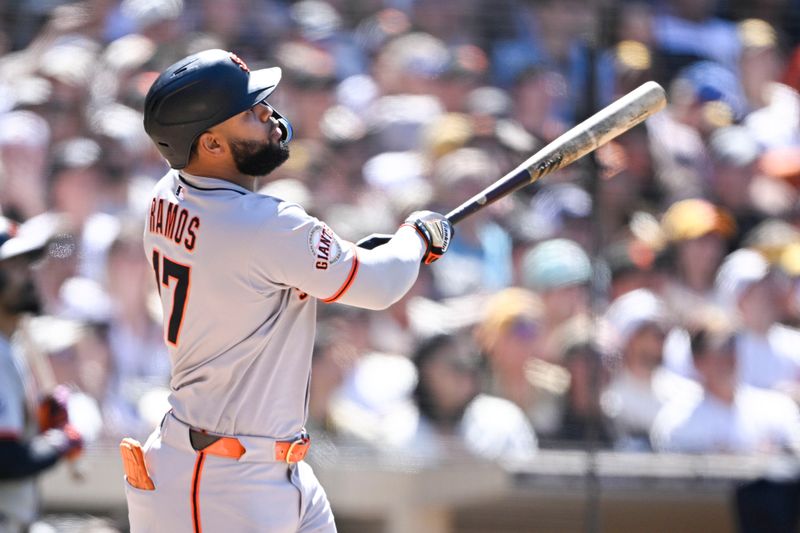Apr 30, 2025; San Diego, California, USA; San Francisco Giants left fielder Heliot Ramos (17) hits a solo home run during the seventh inning against the San Diego Padres at Petco Park. Mandatory Credit: Denis Poroy-Imagn Images
