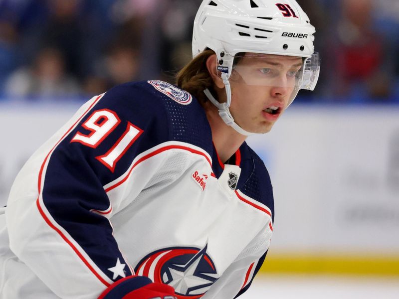 Dec 30, 2023; Buffalo, New York, USA;  Columbus Blue Jackets center Kent Johnson (91) looks for the puck during the first period against the Buffalo Sabres at KeyBank Center. Mandatory Credit: Timothy T. Ludwig-USA TODAY Sports