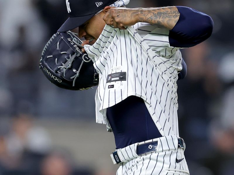 May 20, 2024; Bronx, New York, USA; New York Yankees starting pitcher Marcus Stroman (0) untucks his jersey after being taken out of the game against the Seattle Mariners during the eighth inning at Yankee Stadium. Mandatory Credit: Brad Penner-USA TODAY Sports